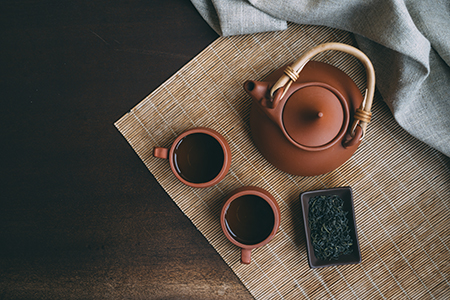 Chinese Tea Ceremony. Brown ceramic teapot and brown tea cup .Gr