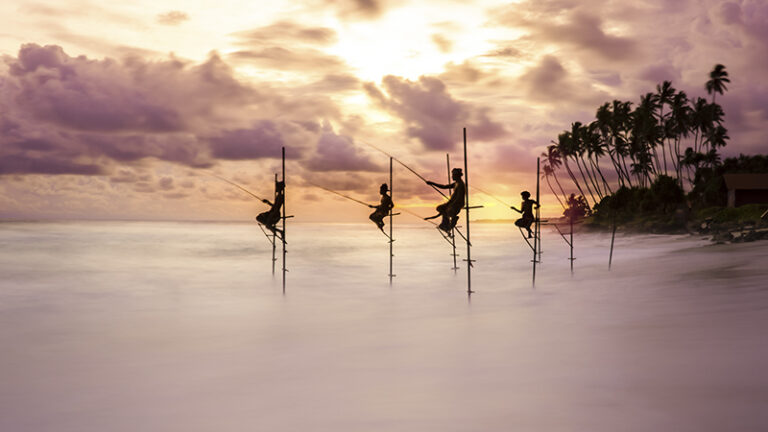 Traditional stilt fishermen try their luck with the changing tide at sunset in Koggala, Sri Lanka. It showcases the water movement in contrast to the stillness of the fishermen. Traditional, artisanal fishing methods like these, used for subsistence do not pose significant threats to the ocean’s natural resources. On the contrary, these make local communities stakeholders to the ocean’s health.