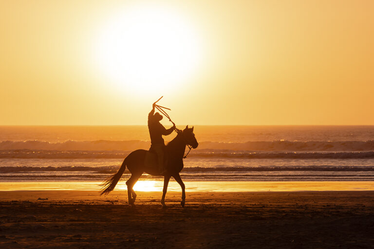 A lone rider enjoying a moment at sunset on the Essaouira Beach in Morocco. Local communities like these are stakeholders to the beach and ocean health and need to look after its health, notably by reducing pollution along the shore – especially plastic.,