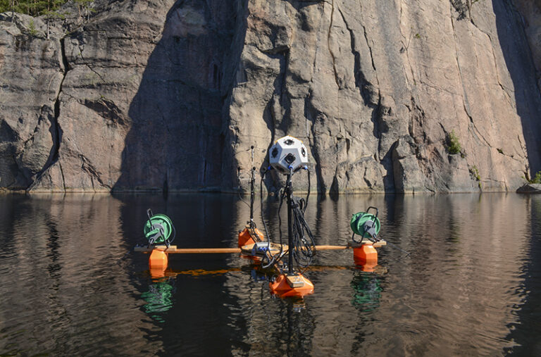 Researchers navigate a specially designed raft equipped with acoustic measurement instruments provided by Riitta Rainio, Archeologist, Finland