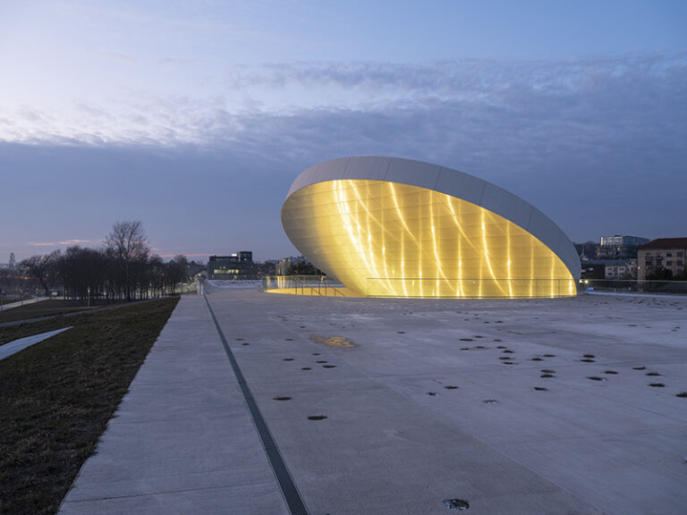 An aluminum-clad disc creates a dramatic entrance portal on the rooftop.