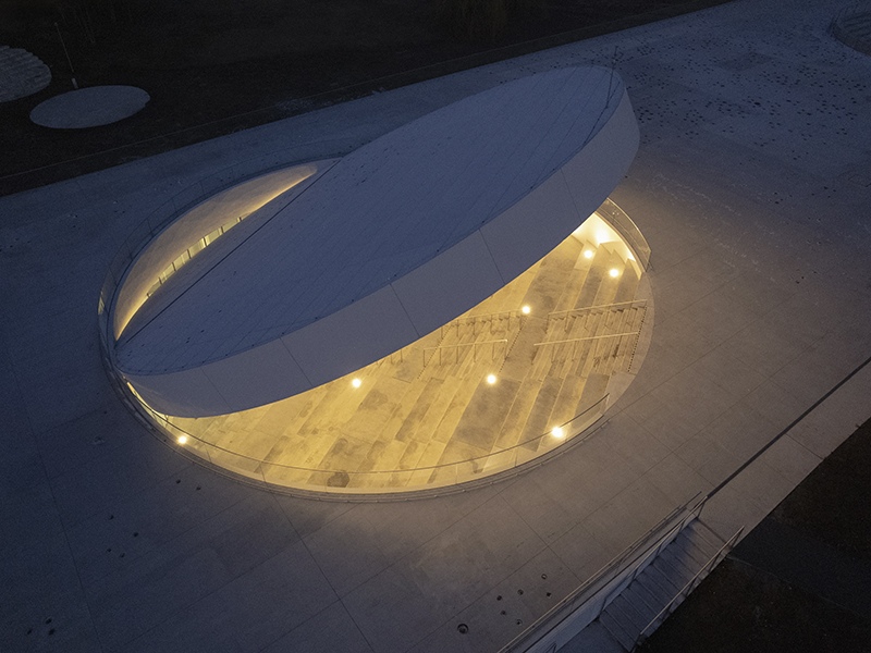 An aluminum-clad disc creates a dramatic entrance portal on the rooftop.