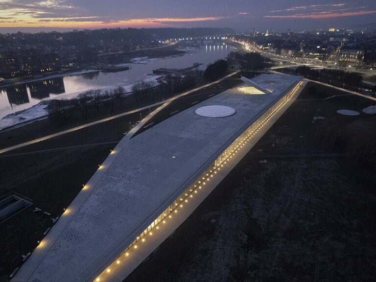 An aluminum-clad disc creates a dramatic entrance portal on the rooftop.