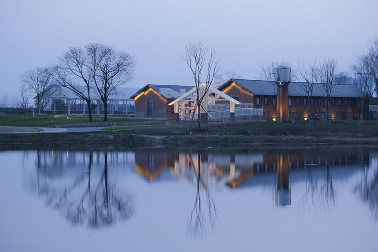 The Floating Seeds Project: Building reflected in the pond, Qinglong Lake Wetland in Chengdu Ring City Ecological Park, China