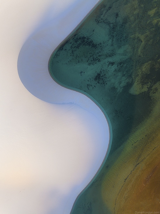 Emerald lagoons nestled within white sand dunes at Lençóis Maranhenses, Brazil by Daniel Kordan