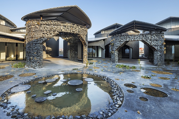 Planting beds and ponds establish a biodiverse landscape throughout the site.