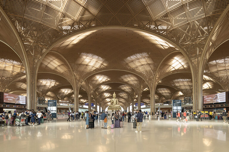 Sculptures and planting feature inside the terminal's central hall, where the vaulted ceiling reaches its dramatic crescendo. Native Romduol trees and a curated collection of hand-crafted sculptures celebrate Cambodian culture while the latticed soffit creates warm, filtered daylight throughout the space.