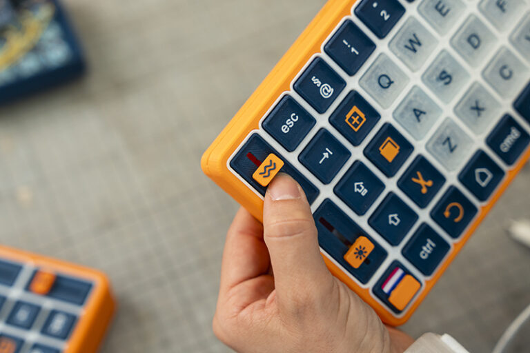 The OnCue system: a modular keyboard paired with a haptic wearable device designed to support people with Parkinson's disease.