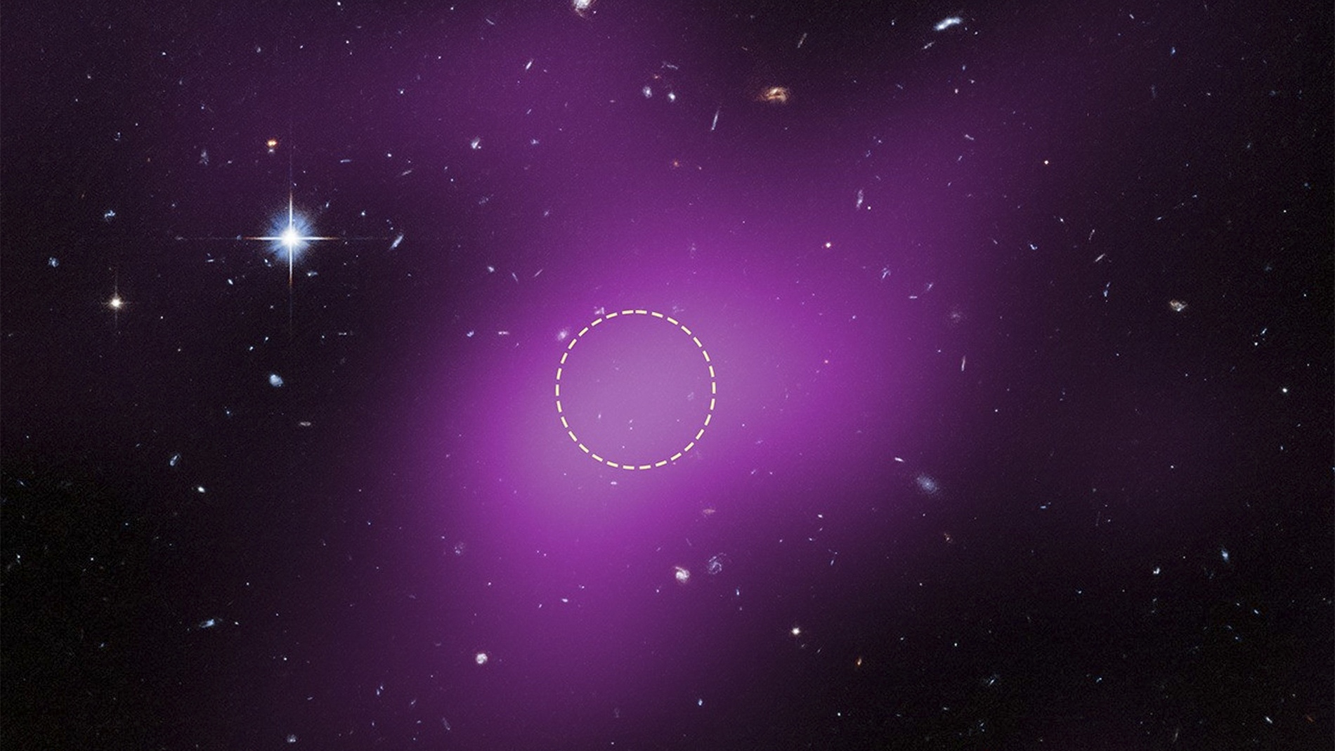 Cloud-9 located approximately 16 million light-years from Earth. Magenta represents VLA radio data detecting hydrogen gas; the dashed circle marks where Hubble's Advanced Camera for Surveys confirmed the absence of stars, proving this is a starless gas cloud dominated by dark matter rather than a dim dwarf galaxy. Visible objects are background galaxies.