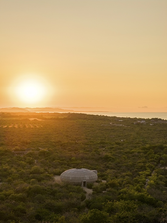 The Mushroom Pavilion in golden sunrise light amid the coastal scrubland of Oaxaca