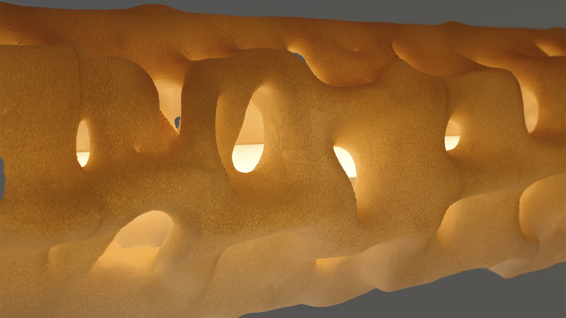 ALHERD pendant lamp, YET FAB. The 3D printed surface glows from within, light finding its way through the computational geometry. Super Playground, Superstudio, Milan Design Week 2026.