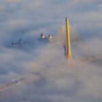 Danjiang Bridge, designed by Zaha Hadid Architects, emerges from a rare ground-hugging advection fog over the Tamsui River estuary, March 18, 2026.