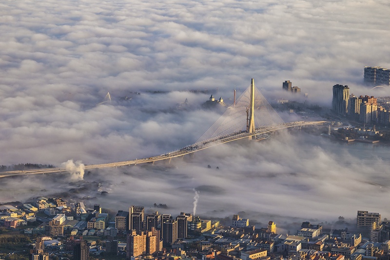 Danjiang Bridge emerging from a sea of clouds, New Taipei City