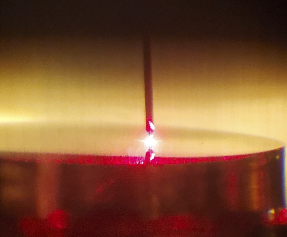The glowing tip of the scanning tunneling microscope during a measurement