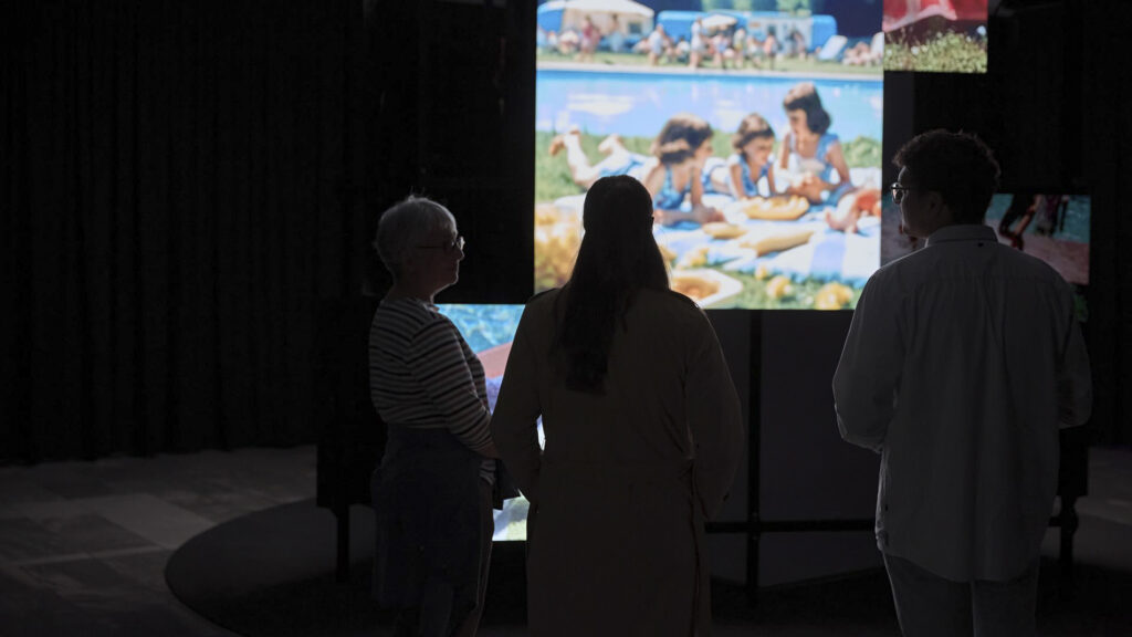 Visitors stand before reconstructed memories at The Lost Sense, an exhibition in Berlin (2025) exploring the bond between smell and memory. The images were rebuilt from the recollections of people who lost their sense of smell during the COVID-19 pandemic.