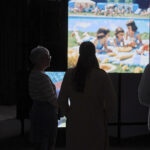 Visitors stand before reconstructed memories at The Lost Sense, an exhibition in Berlin (2025) exploring the bond between smell and memory. The images were rebuilt from the recollections of people who lost their sense of smell during the COVID-19 pandemic.