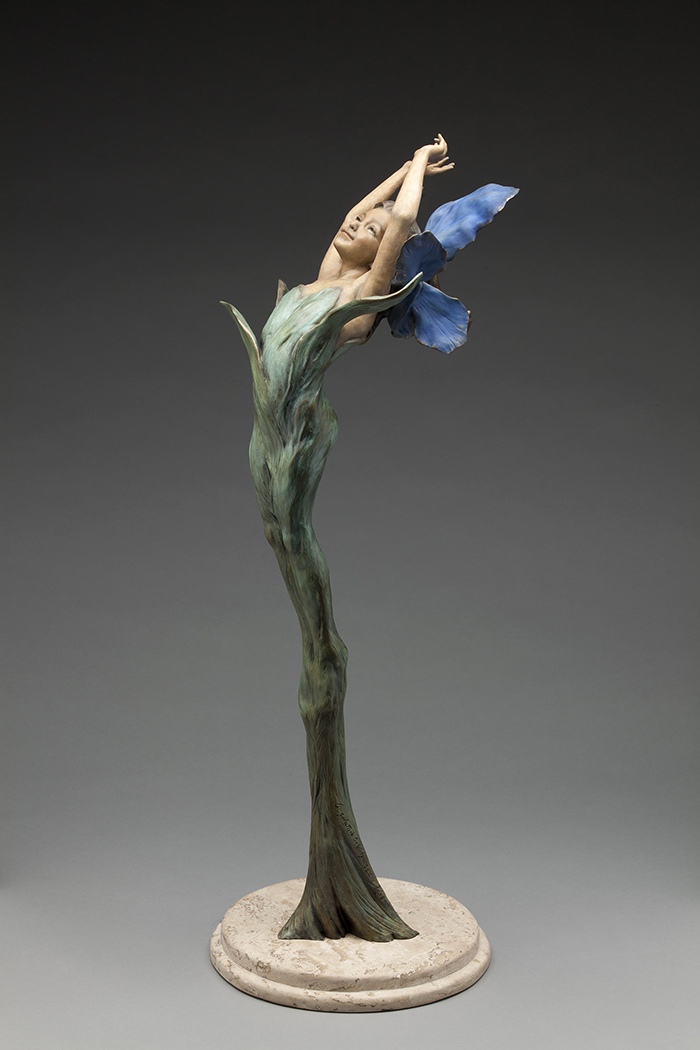 Bloom. A figure rising from a leaf stalk, with petals for wings, bronze.