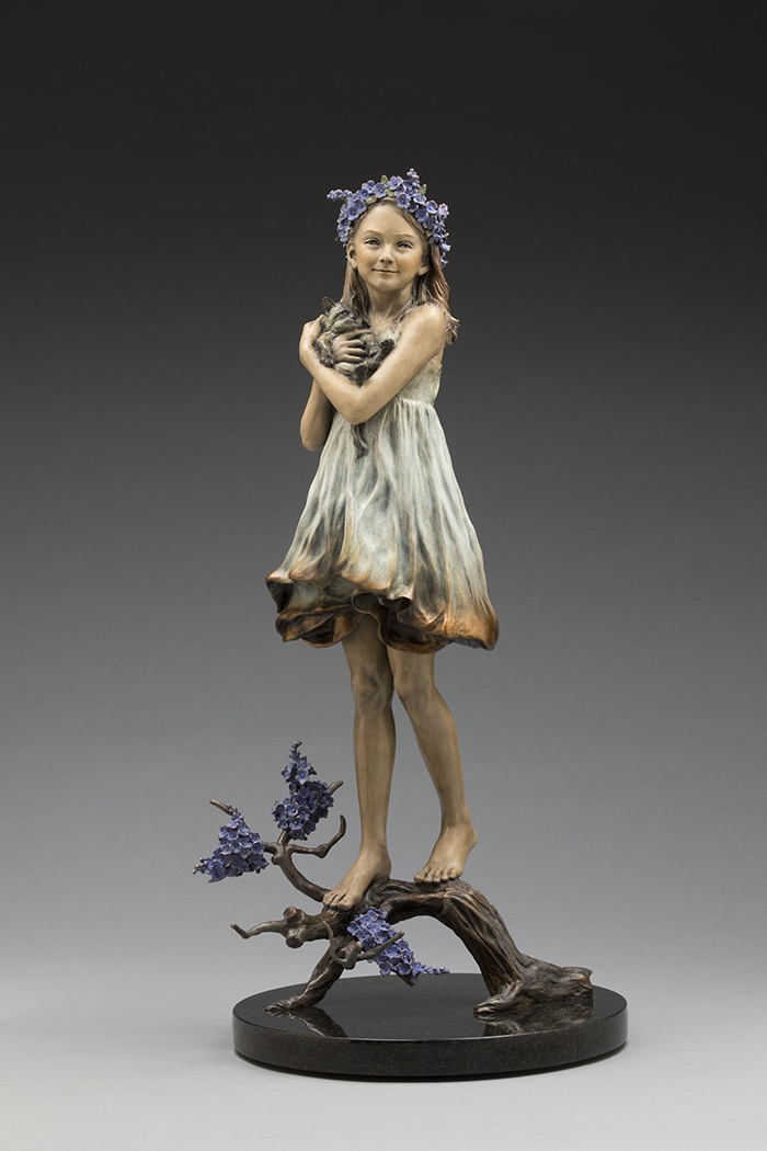 Harmony. A girl with a crown of blue flowers holds a kitten close, bronze.