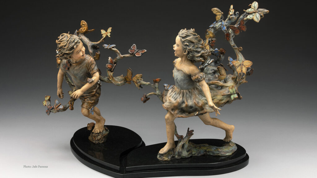 Where Butterflies Lead. Two children run laughing through a swirl of butterflies, bronze