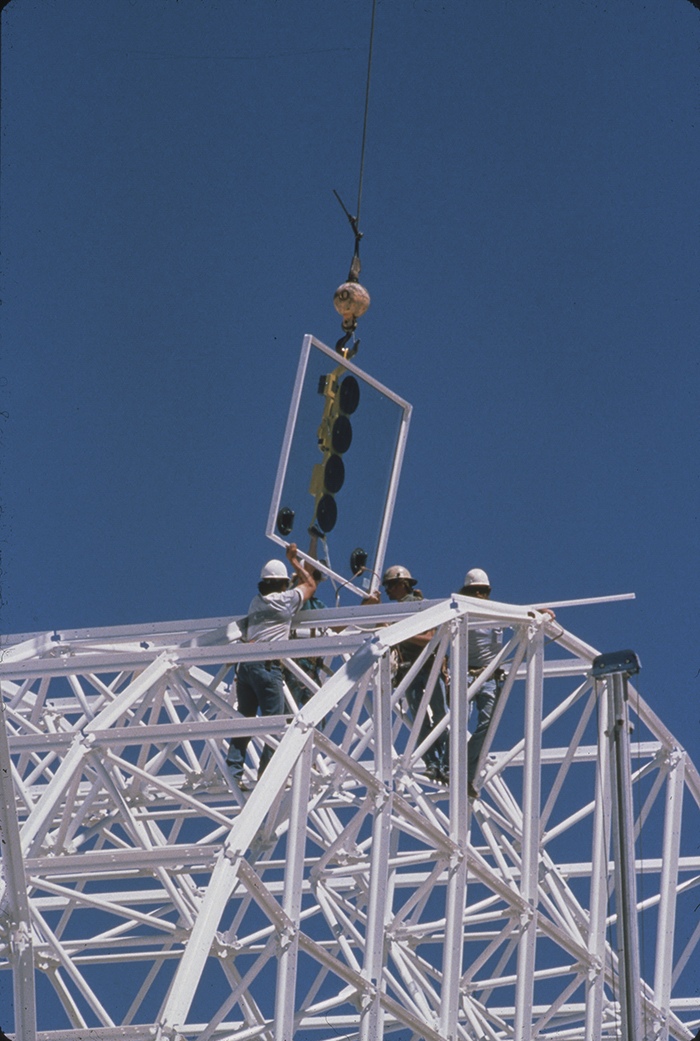 Workers lift the first glazing panel into place at Biosphere 2