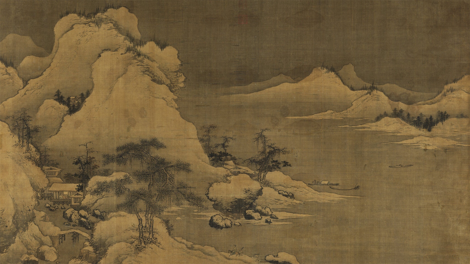 A wide Song dynasty ink landscape of snow-covered mountains, with dwellings and pines along a winding shore, small boats on still water, and a lone traveler on the path below